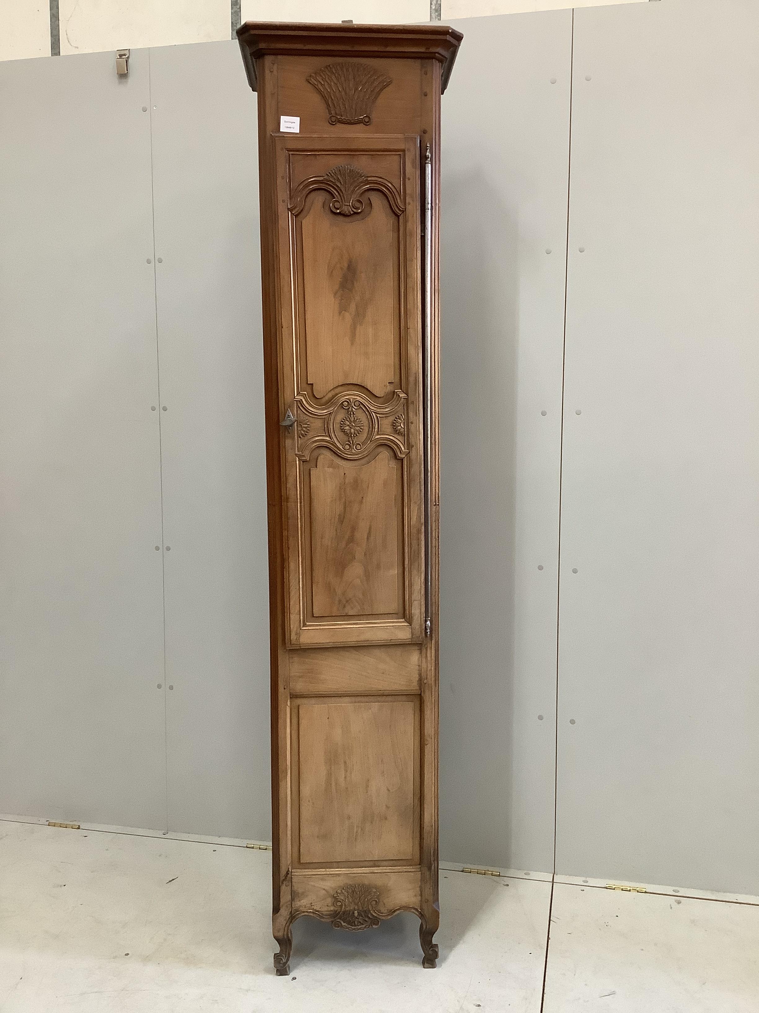 A Louis XV style narrow walnut cabinet, width 48cm, depth 36cm, height 215cm